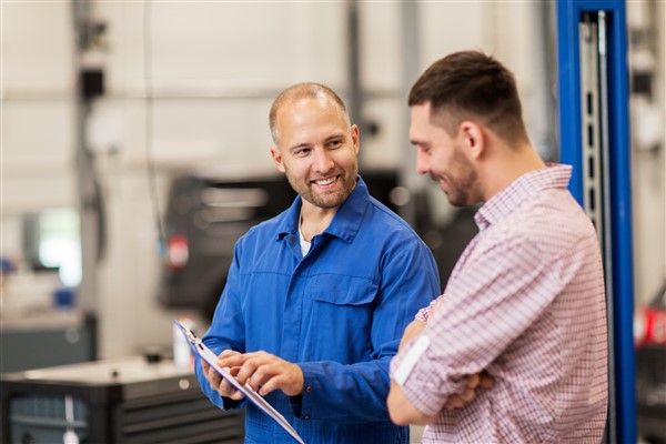 Image of two men talking about the status of his car